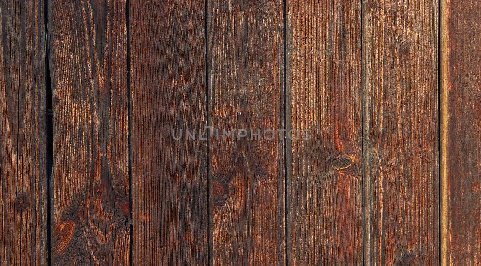 Dark brown board. Old wood background texture Contrasting textured wood background