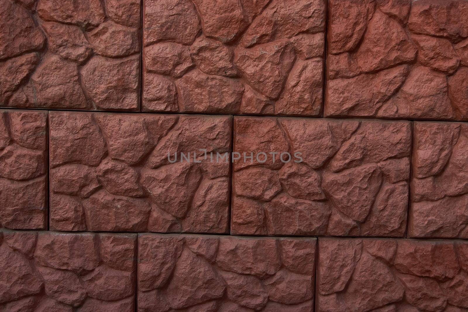 Old brown stone wall Close-up Background of stone tiles with detailed natural texture.
