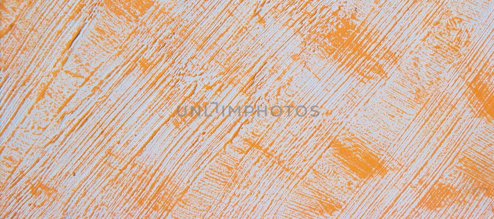 Orange pattern on a white wall. Orange abstract background with stripes and spots. Bright texture for banner or poster