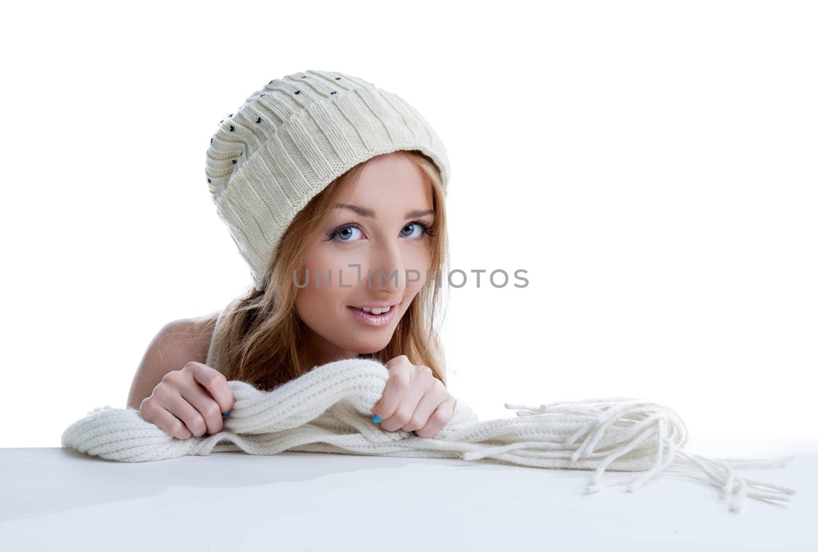 Portrait of beautiful young model shows knitted garment, close-up