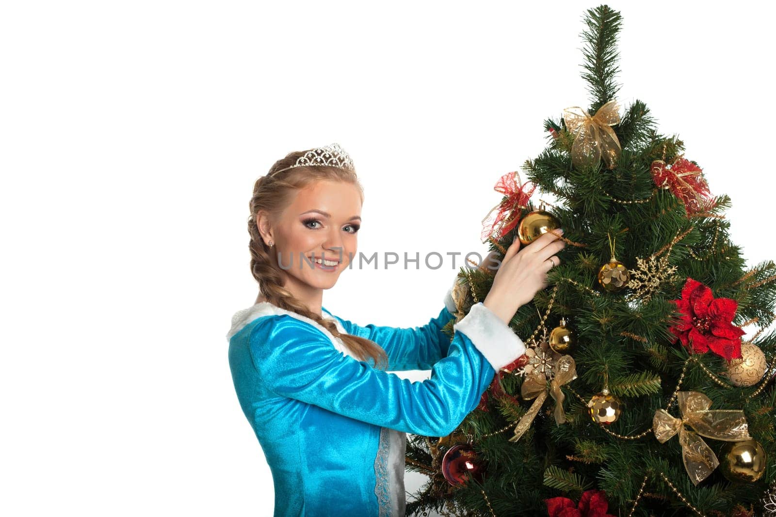 Beautiful Snow Maiden decorating Christmas tree, close-up