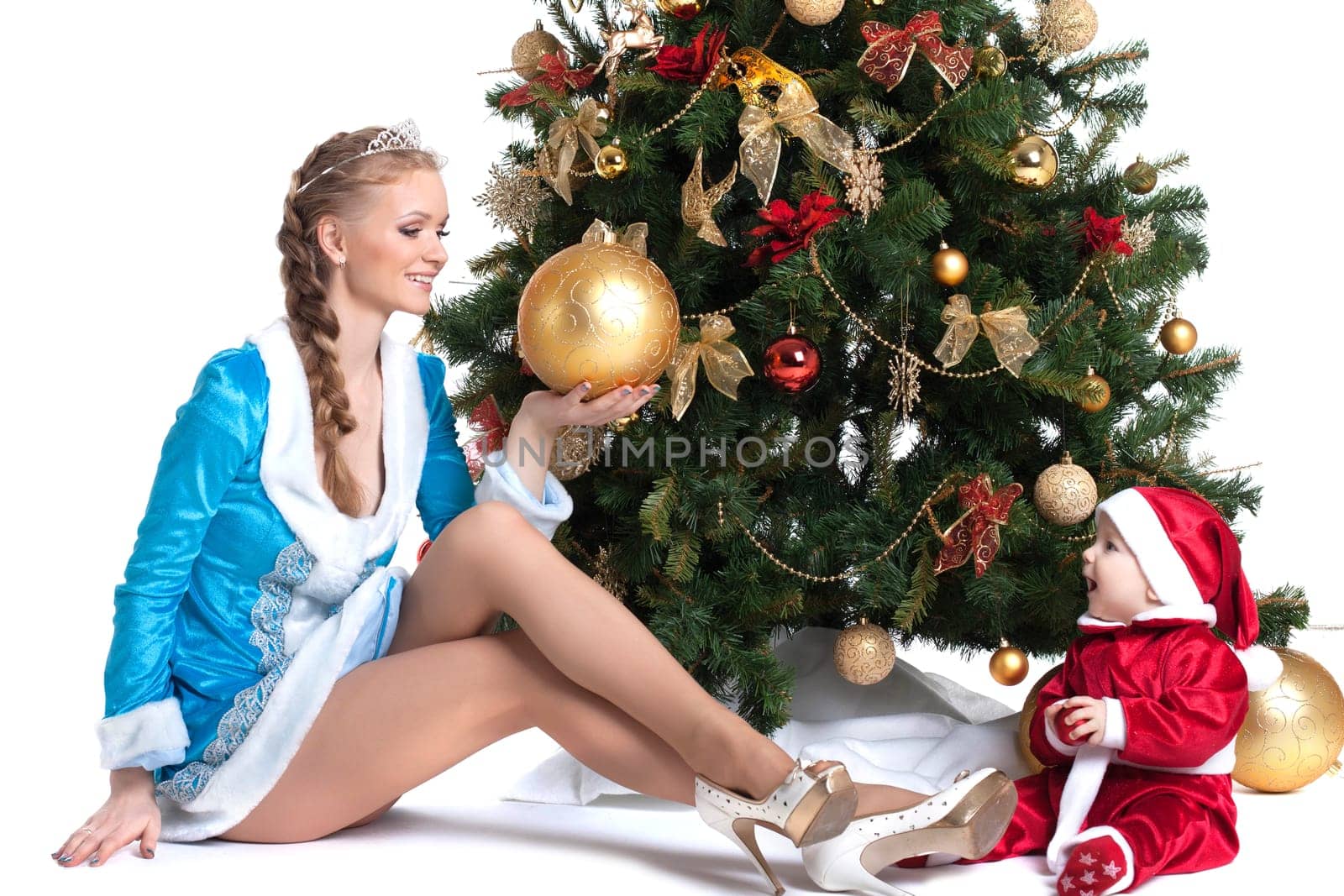 Happy mom and kid posing in Christmas costumes, isolated on white