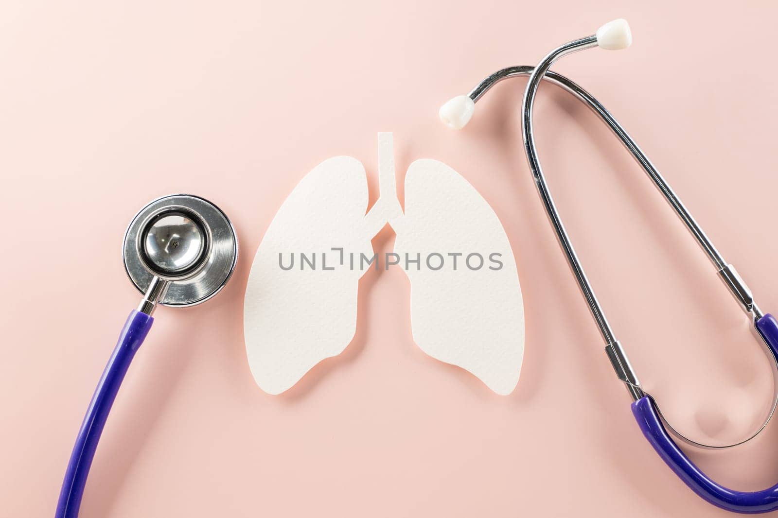 World TB Day. Lungs paper cutting symbol and medical stethoscope on pink background, copy space, lung cancer awareness, concept of world tuberculosis day, banner background, respiratory diseases