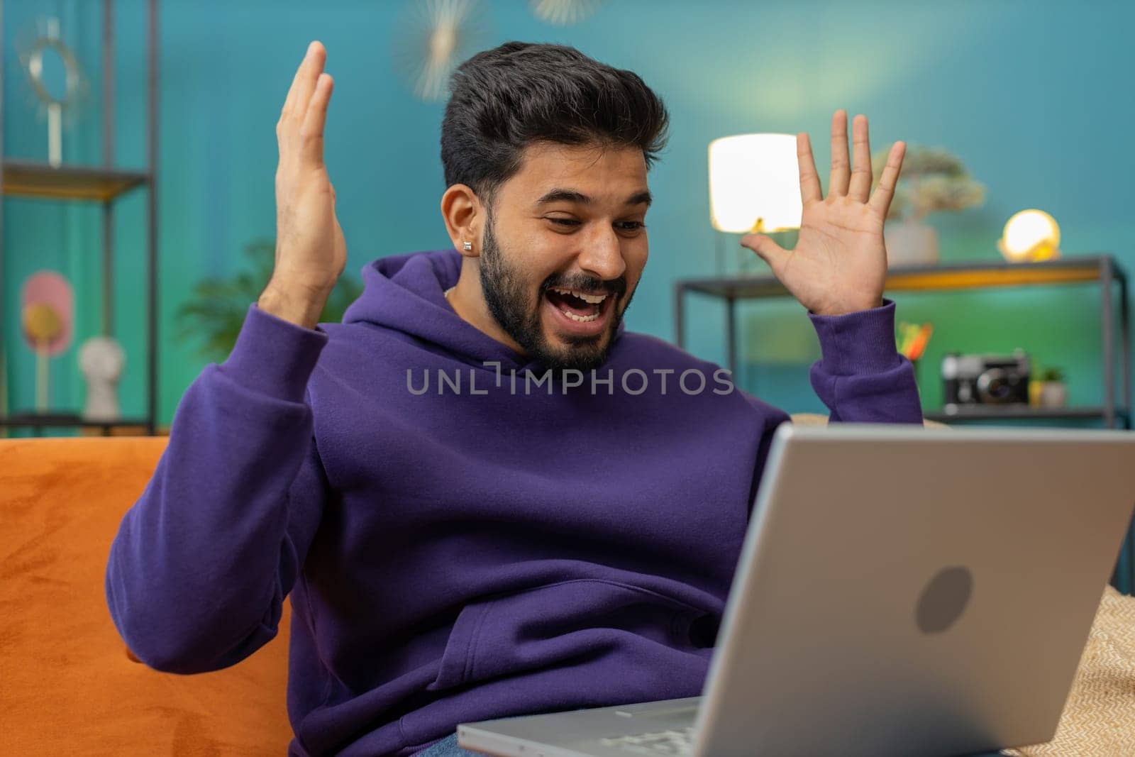 Oh my God Wow. Surprised indian man using laptop computer, receive good news message, shocked by sudden victory, celebrate lottery jackpot win purchases online shopping at home. Lifestyle technologies