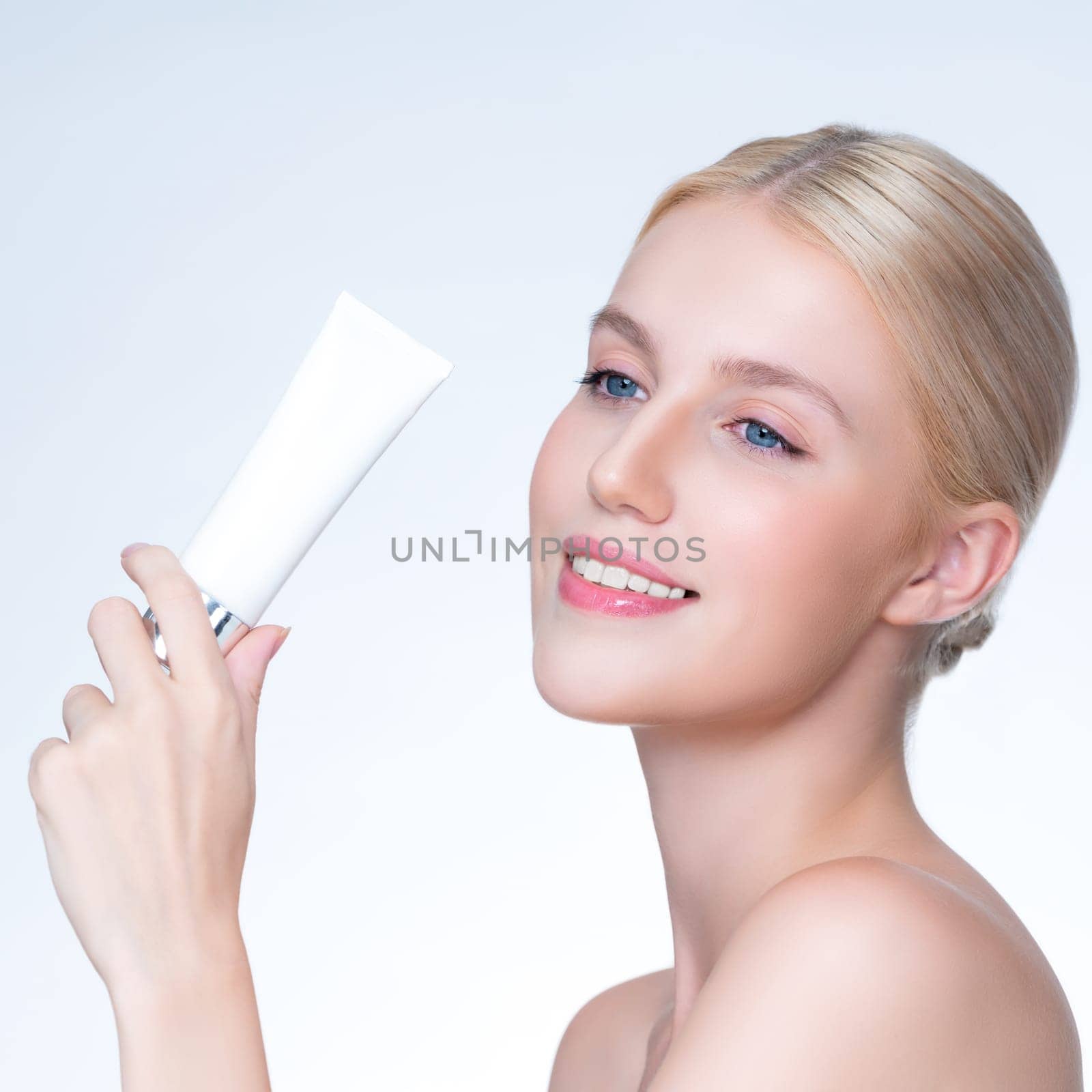 Closeup personable beautiful perfect natural skin woman hold mockup tube moisturizer cream for skincare treatment product advertising expressive facial and gesture expression in isolated background.