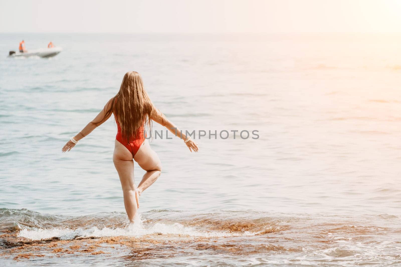 Woman sea yoga. Back view of free calm happy satisfied woman with long hair standing on top rock with yoga position against of sky by the sea. Healthy lifestyle outdoors in nature, fitness concept.