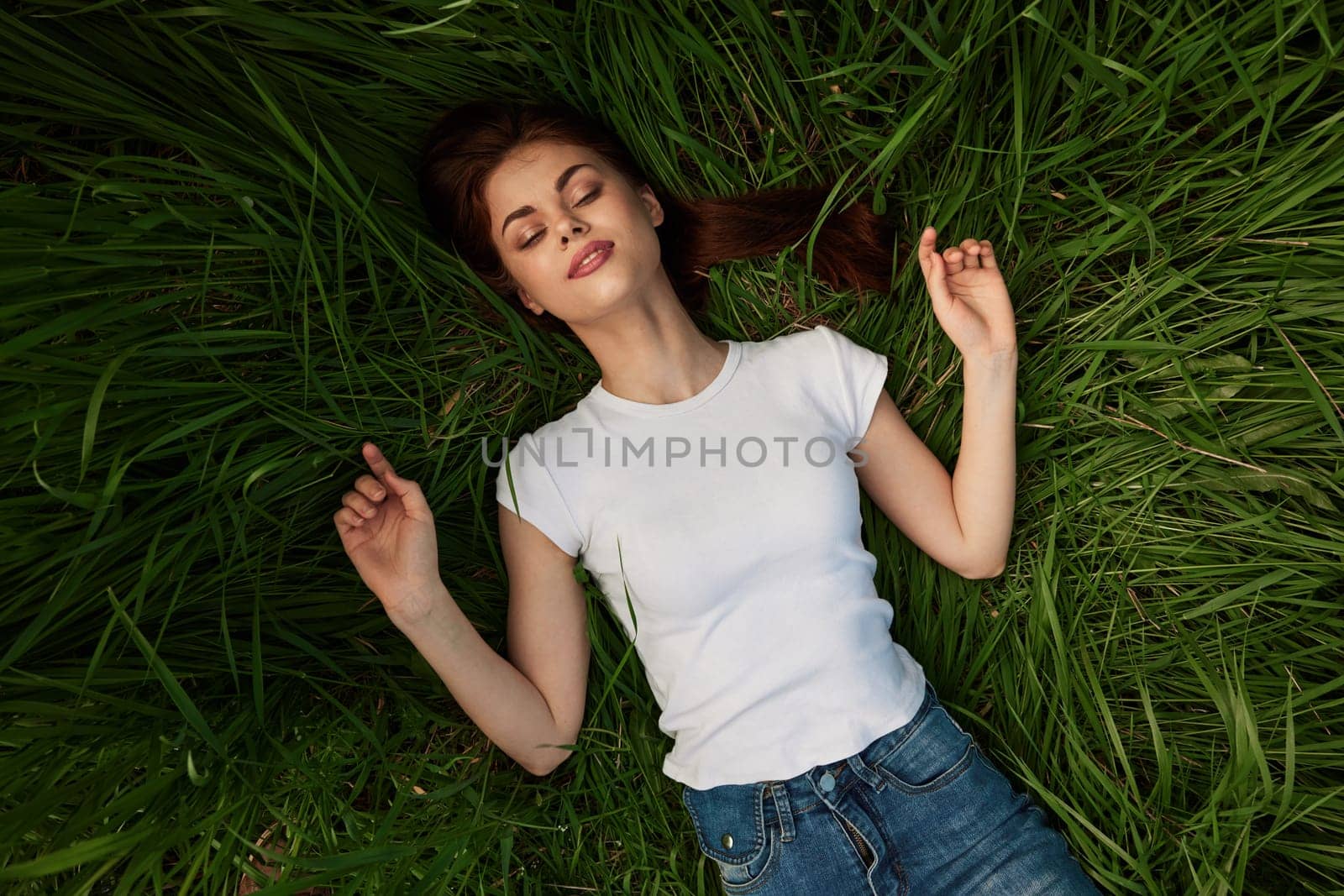 woman dreaming lying on the grass by Vichizh
