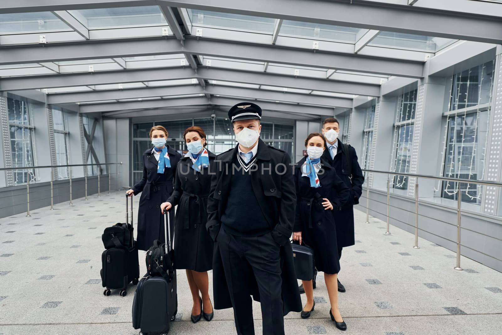 Airplane crew in uniform is going to the work together.