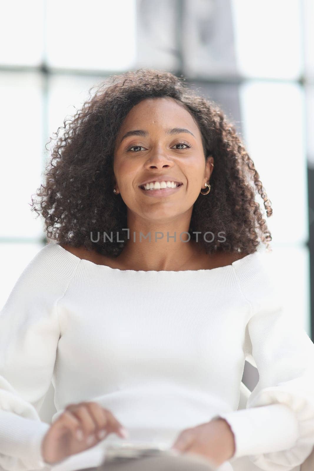 Portrait of a young attractive African American woman using a smartphone.