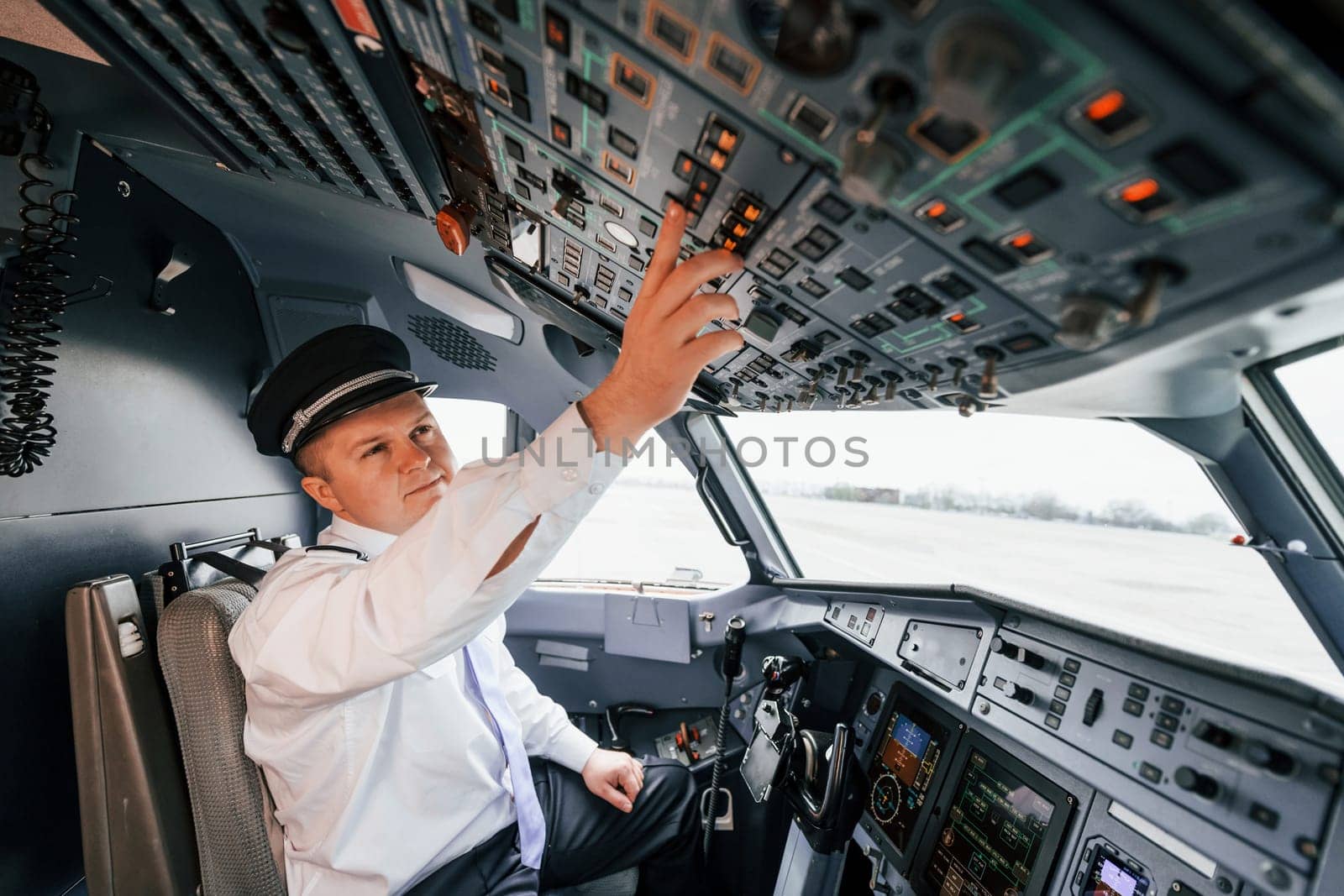 Control of the flight. Pilot on the work in the passenger airplane. Preparing for takeoff by Standret