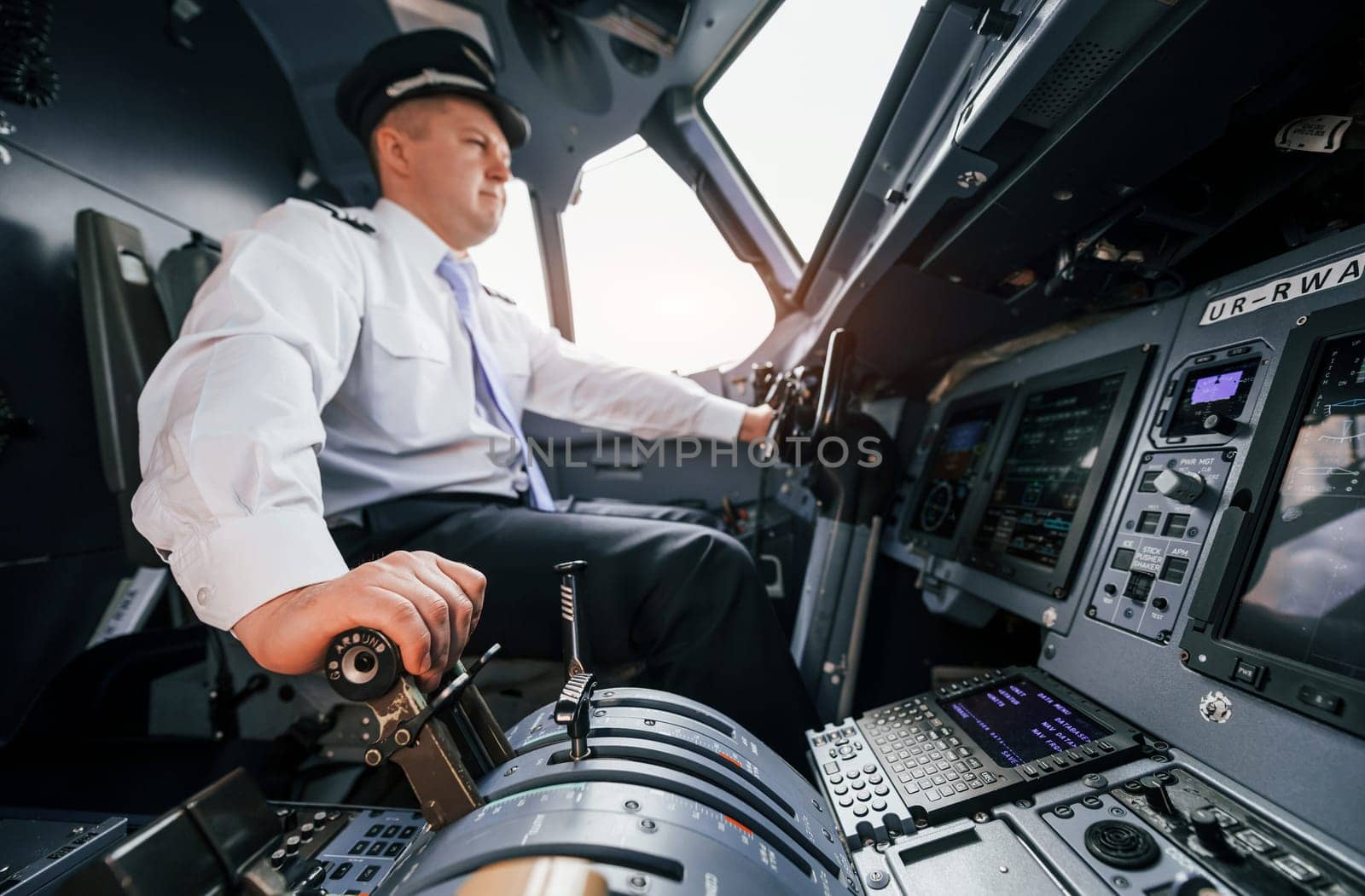 Pilot on the work in the passenger airplane. Preparing for takeoff by Standret