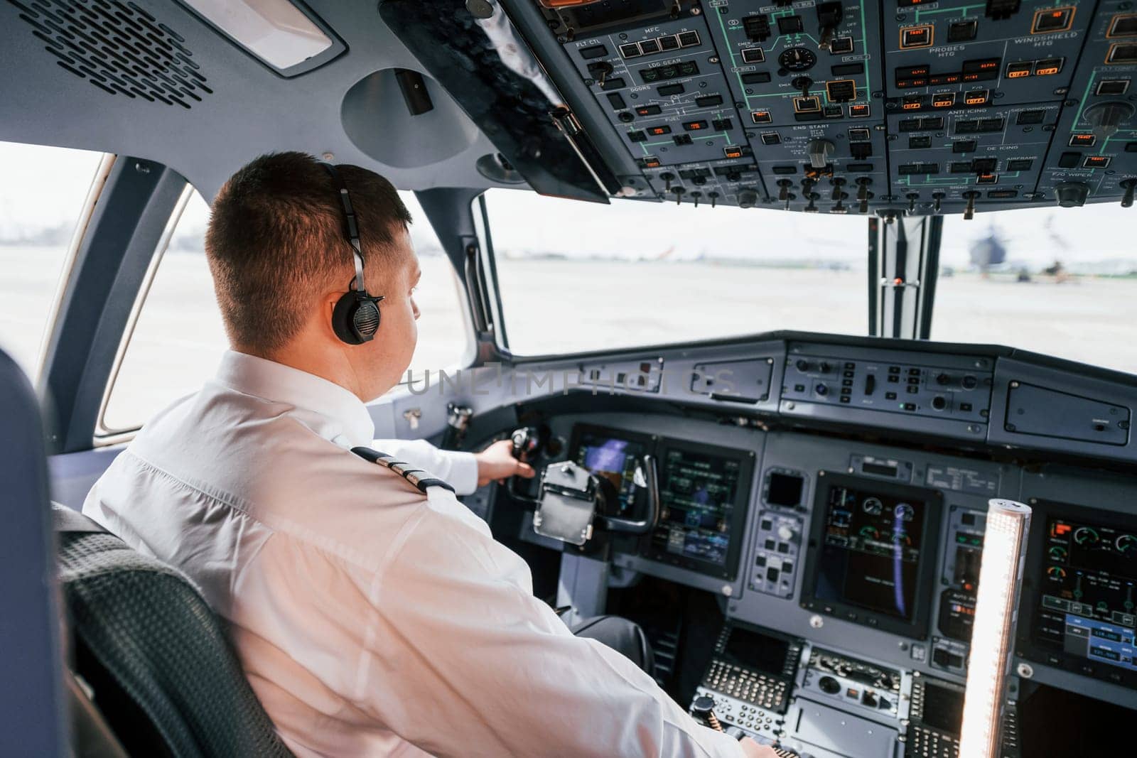 Pilot on the work in the passenger airplane. Preparing for takeoff.