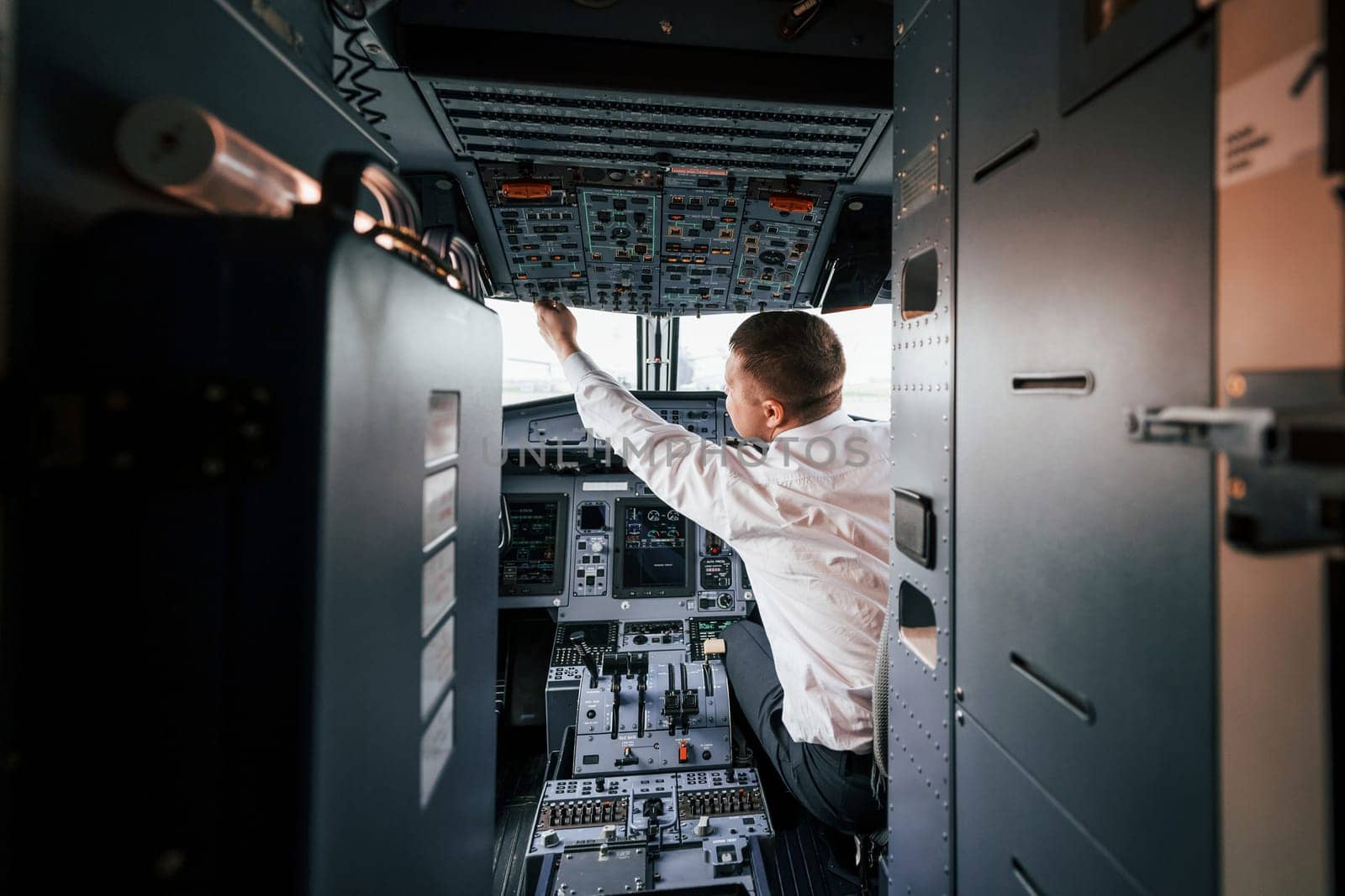 Control of the flight. Pilot on the work in the passenger airplane. Preparing for takeoff.