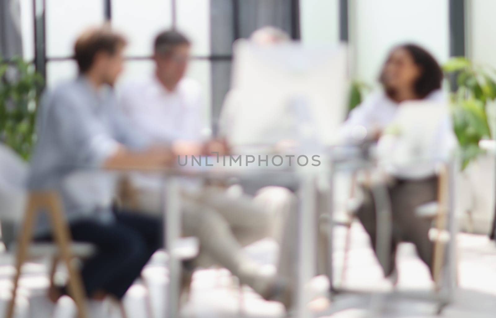 Conversation between managers and employees in the office. Blurred photo.