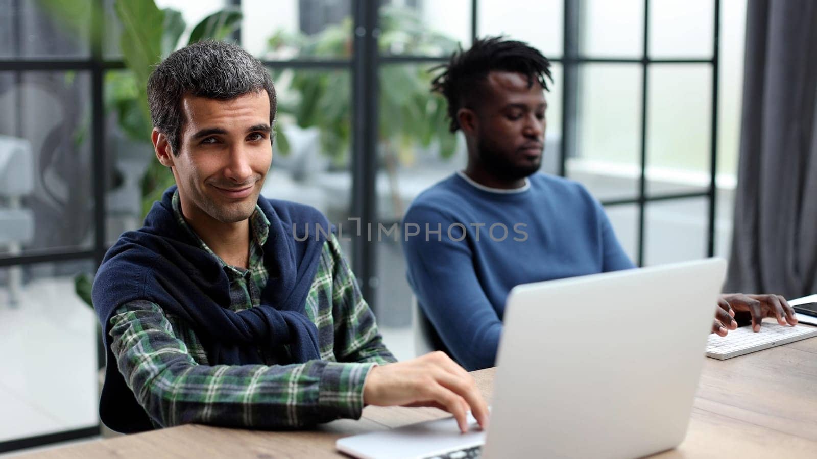 Young multiethnic businessmen working at the negotiating table