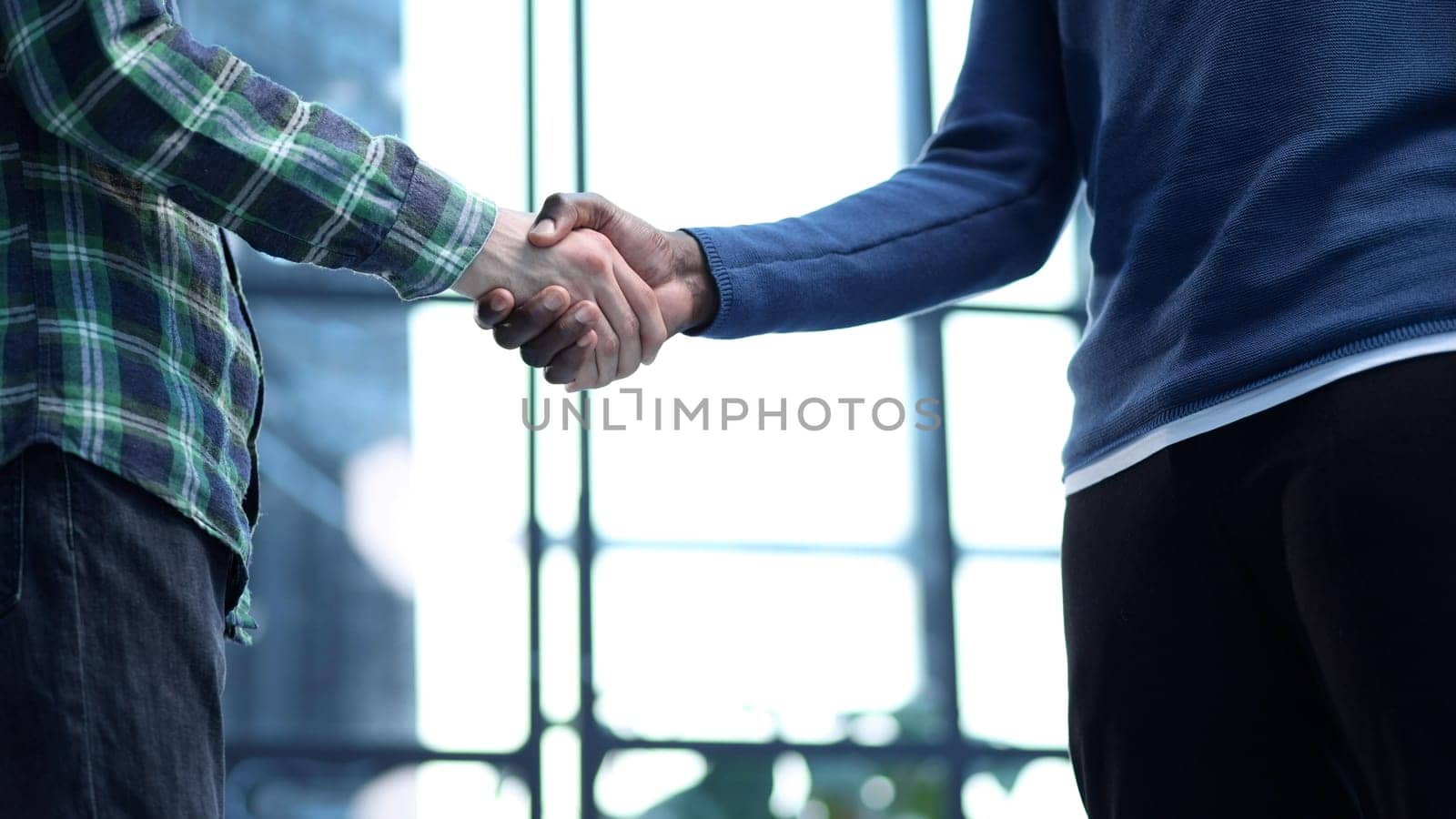 african businessman handshake reliable male partner at team meeting