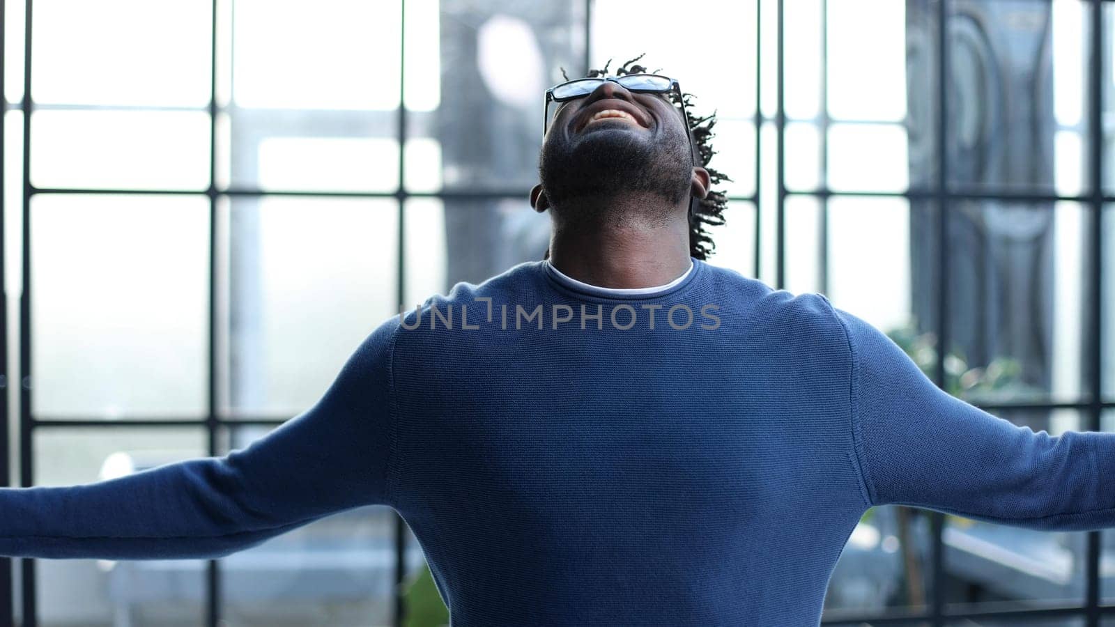 young businessman spread his arms to the side in the office