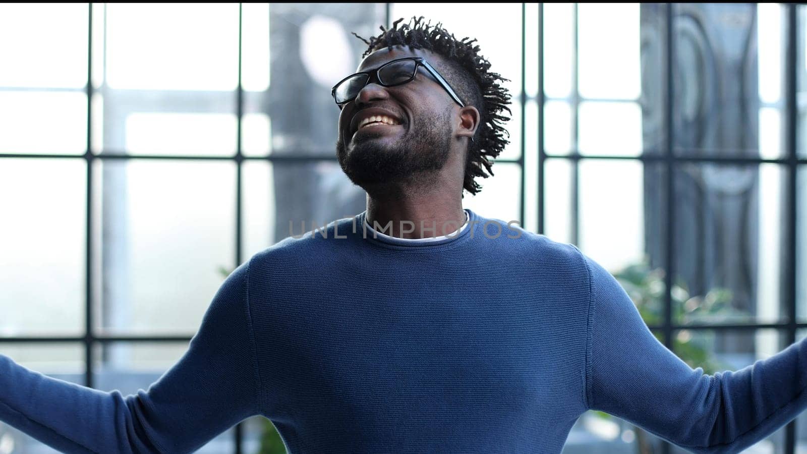 young businessman spread his arms to the side in the office