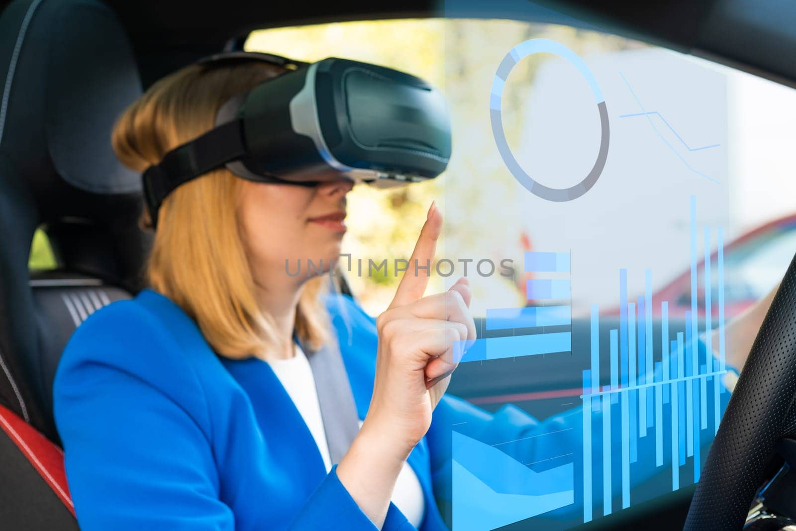 Digitally generated graphics and charts interface managed by business woman in vr googles sitting in the car in a blue suit. Metaverse cyber world technology concept.