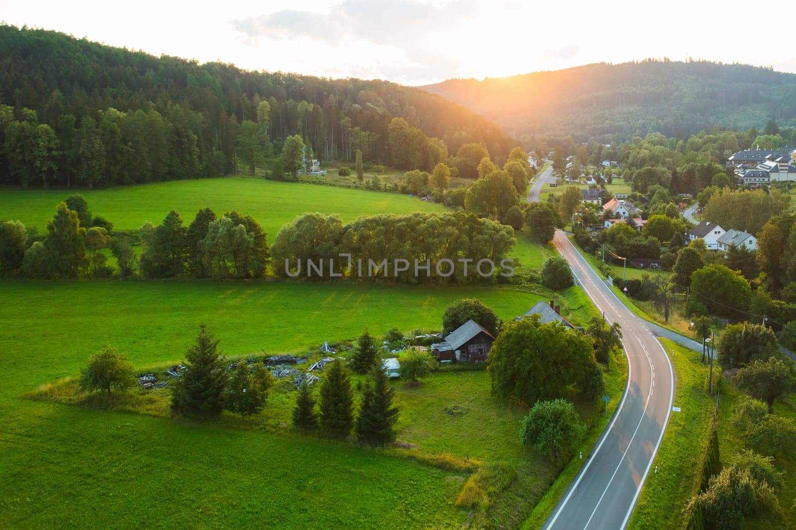 Majestic sunset in the countryside, Small village surrounded by hills with lush trees, Dolni Morava, Czech Republic