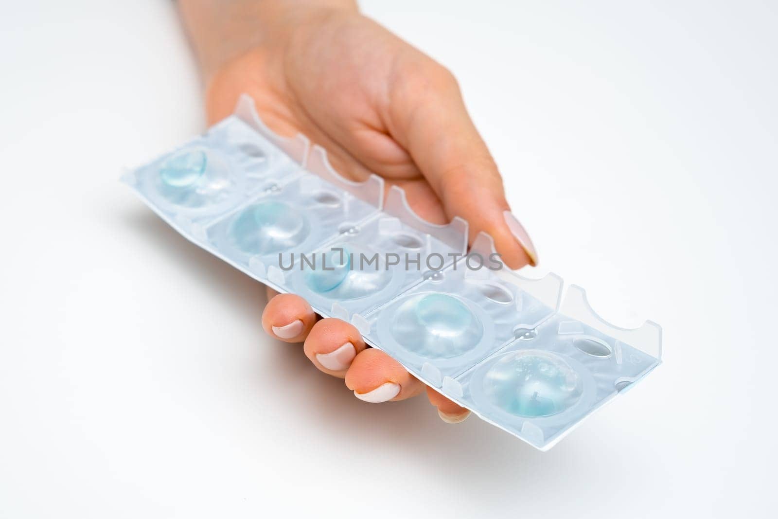 Package of contact lenses in woman hands for improvement of eyesight