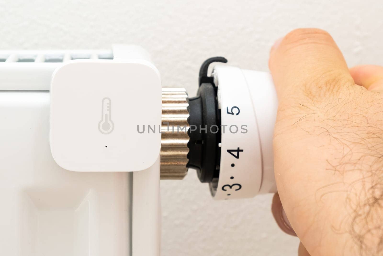 Heat sensor on the battery for temperature control and mens hand regulated thermostat. Increasing price on gas and heating concept