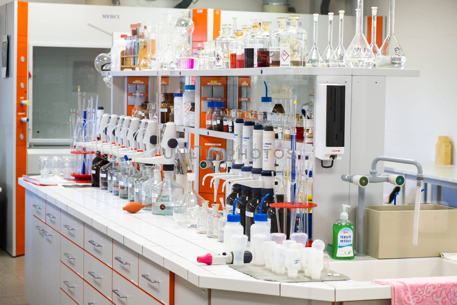 Well equipped chemical laboratory with glassware, pipettes, flasks and bottles. The workplace for research work. November 2021, Prague, Czech Republic.