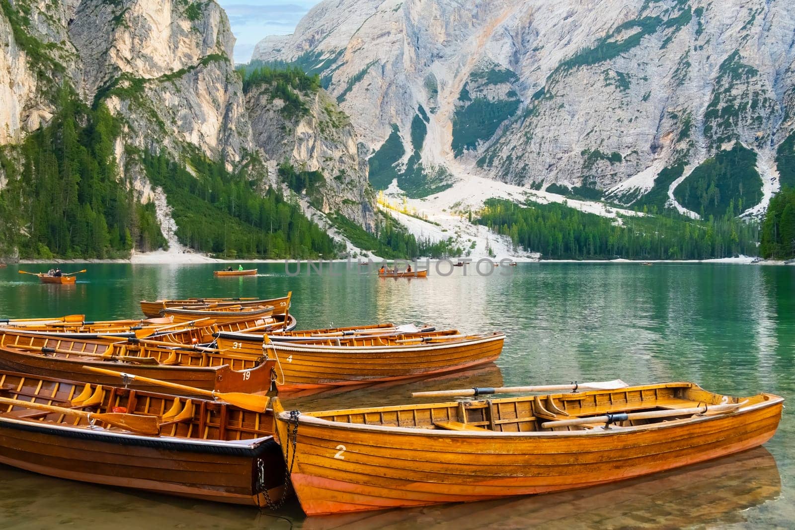 The magnificent Lake Braies with the chain of wooden boats in Dolomites Alps, Italy by vladimka