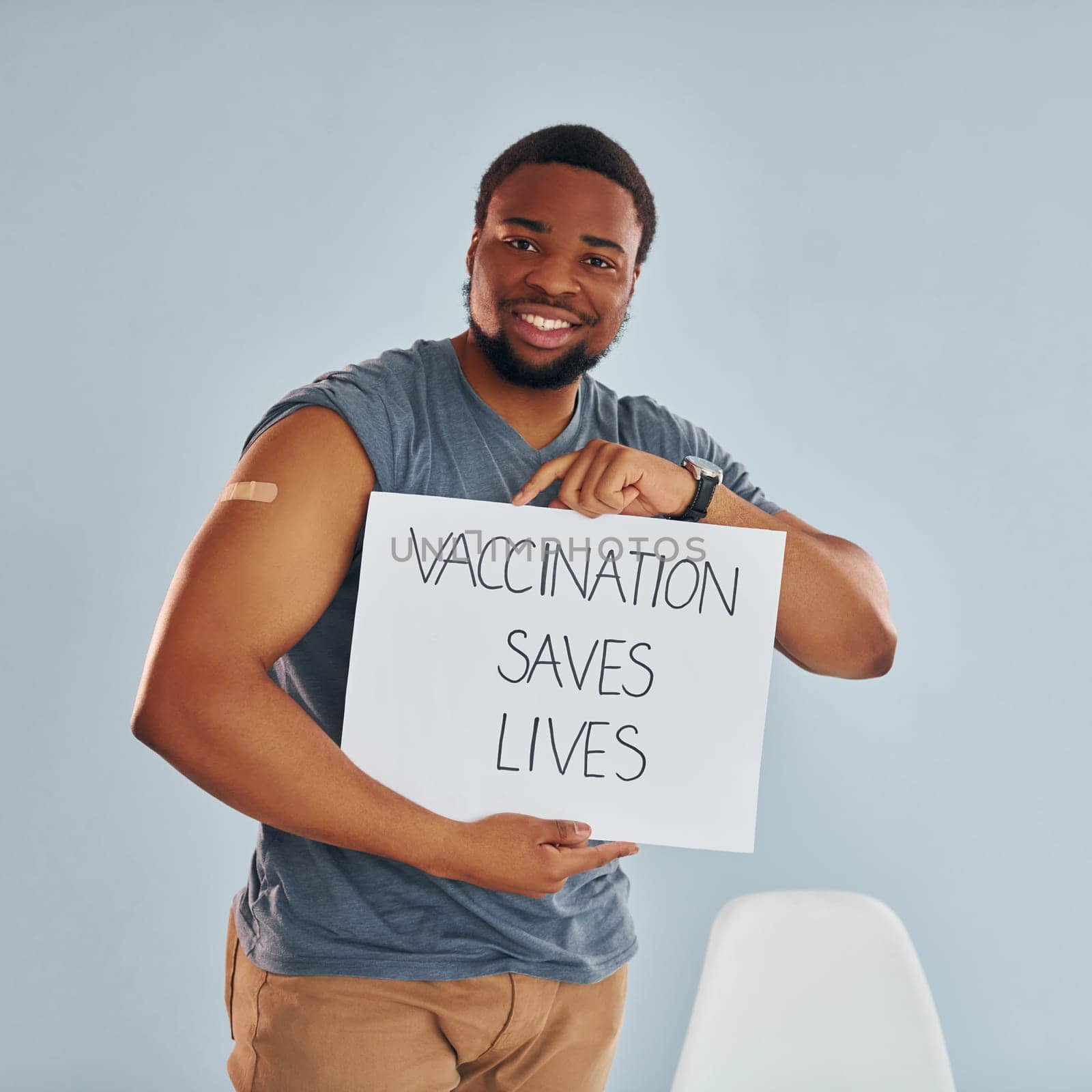 Vaccination saves lives banner. Young african american man after vaccine injection by Standret