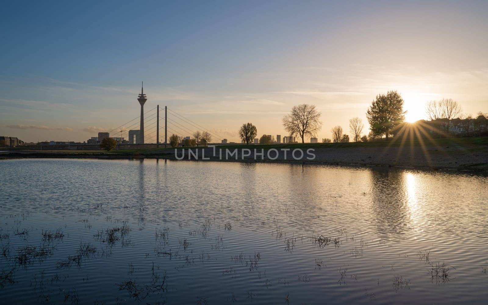 Sunset on the Rhine river with the cityscape of Dusseldorf in the background, Germany