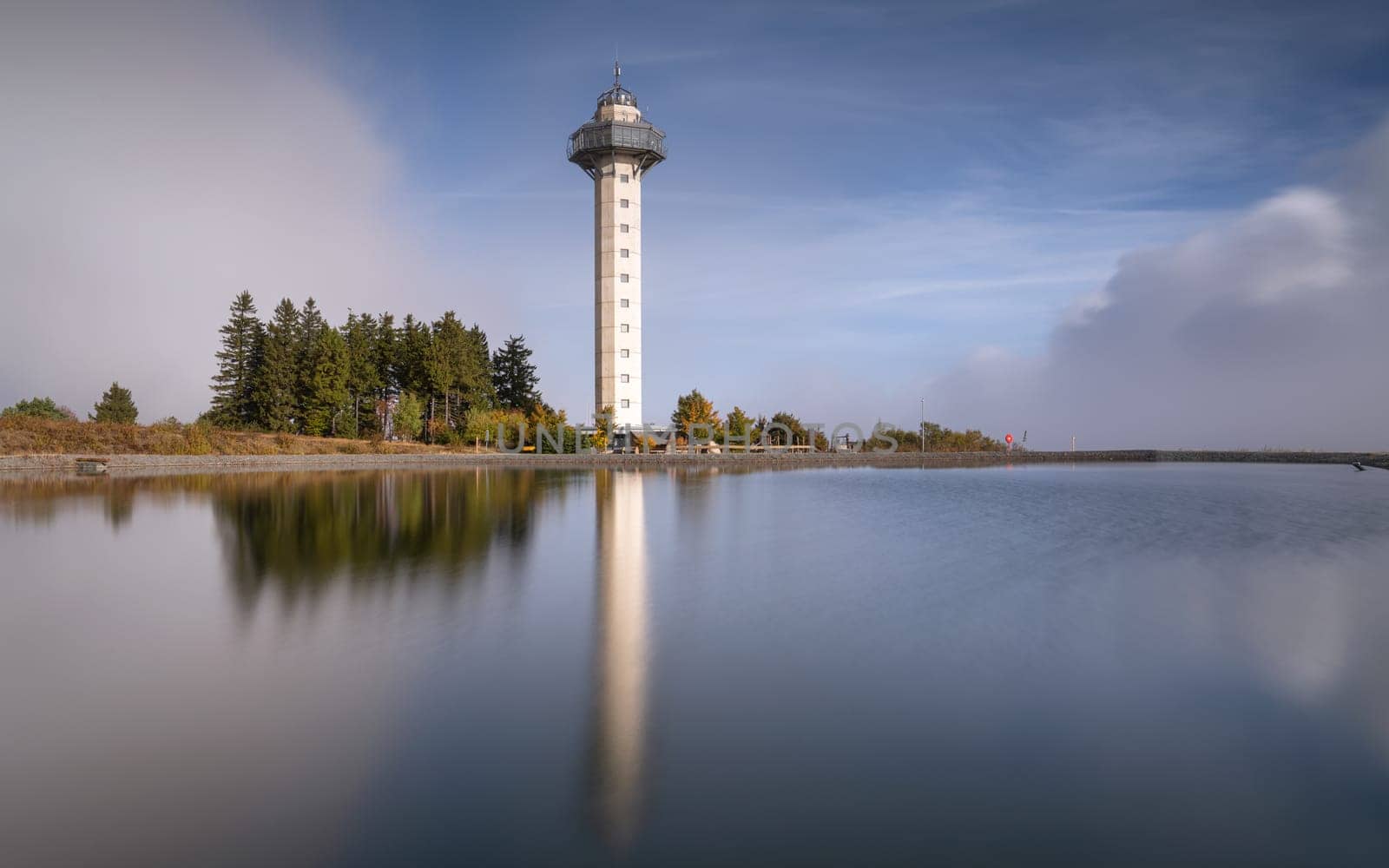 Heather tower close to Willingen with reflection and cloudy sky, Sauerland, Germany