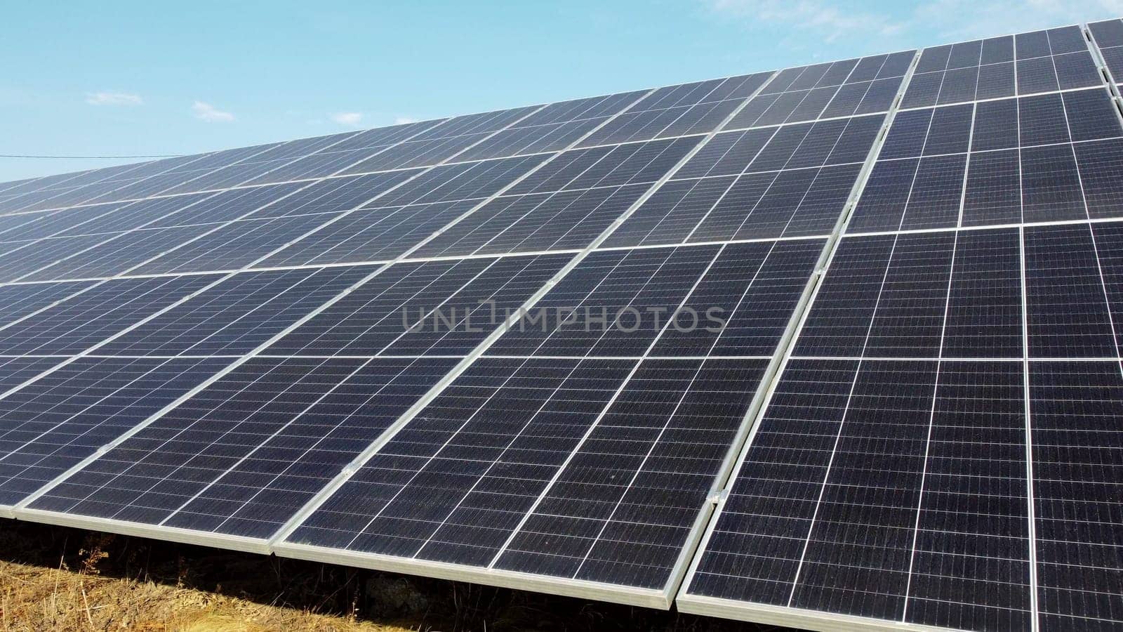 Solar power plant. Flight over modules of solar power station on sunny day. Alternative green electricity power. New modern technology. Renewable electrical energy. photovoltaic modules photobatteries