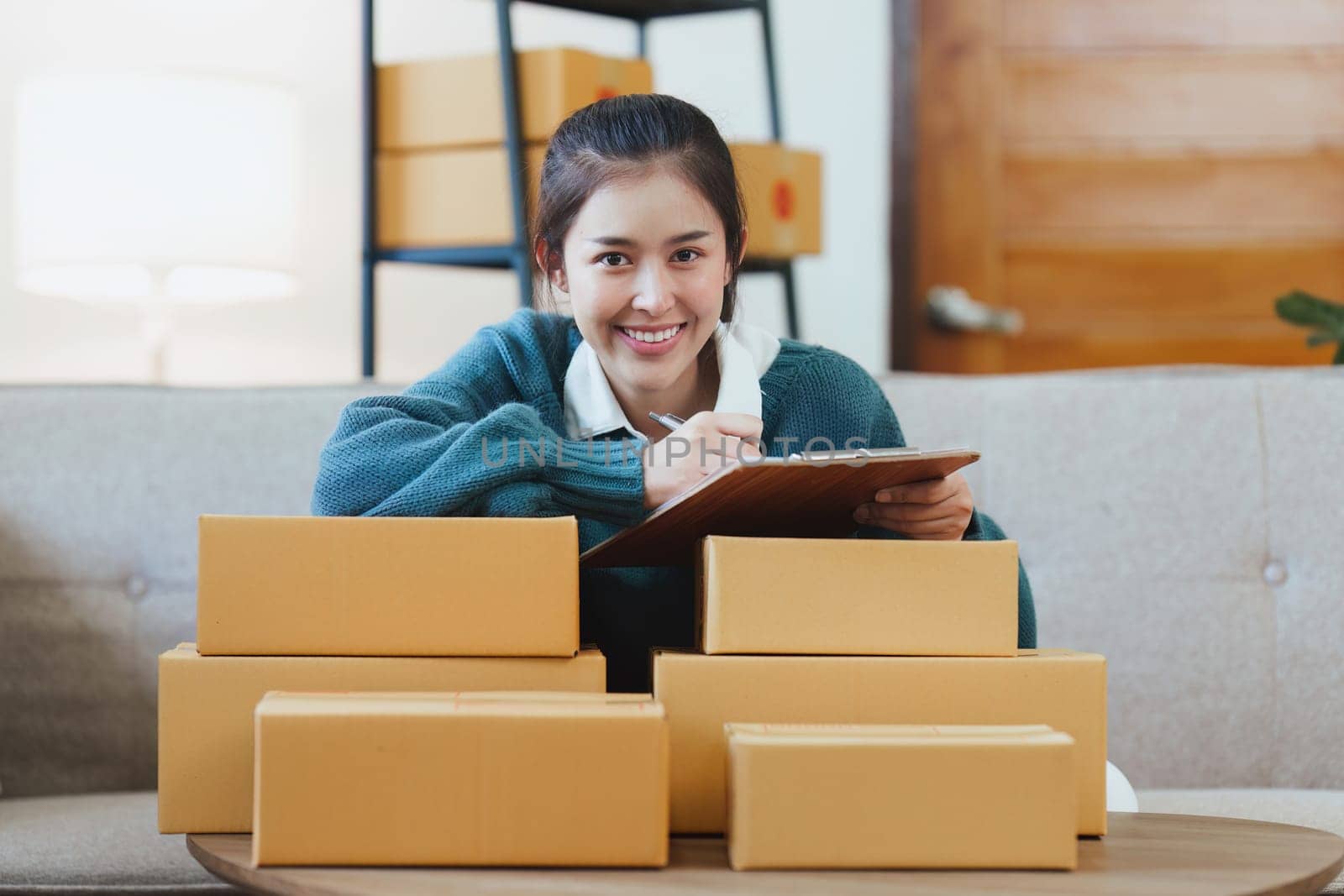 Small businesses SME owners female entrepreneurs check online orders to prepare to pack the boxes, sell to customers, sme business ideas online by itchaznong