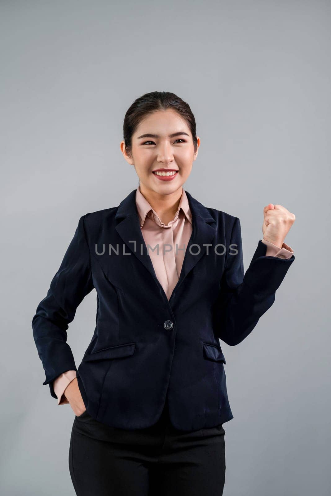 Confident young asian businesswoman in formal suit making hand gesture to indicate promotion or advertising with surprised face expression and gesture on isolated background. Enthusiastic