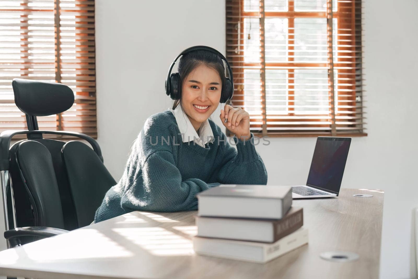 Portrait young asian woman using laptop for online learning at home by nateemee