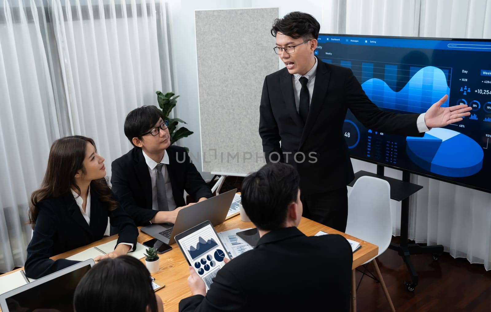 Confidence and young asian businessman give presentation to promote harmony. by biancoblue