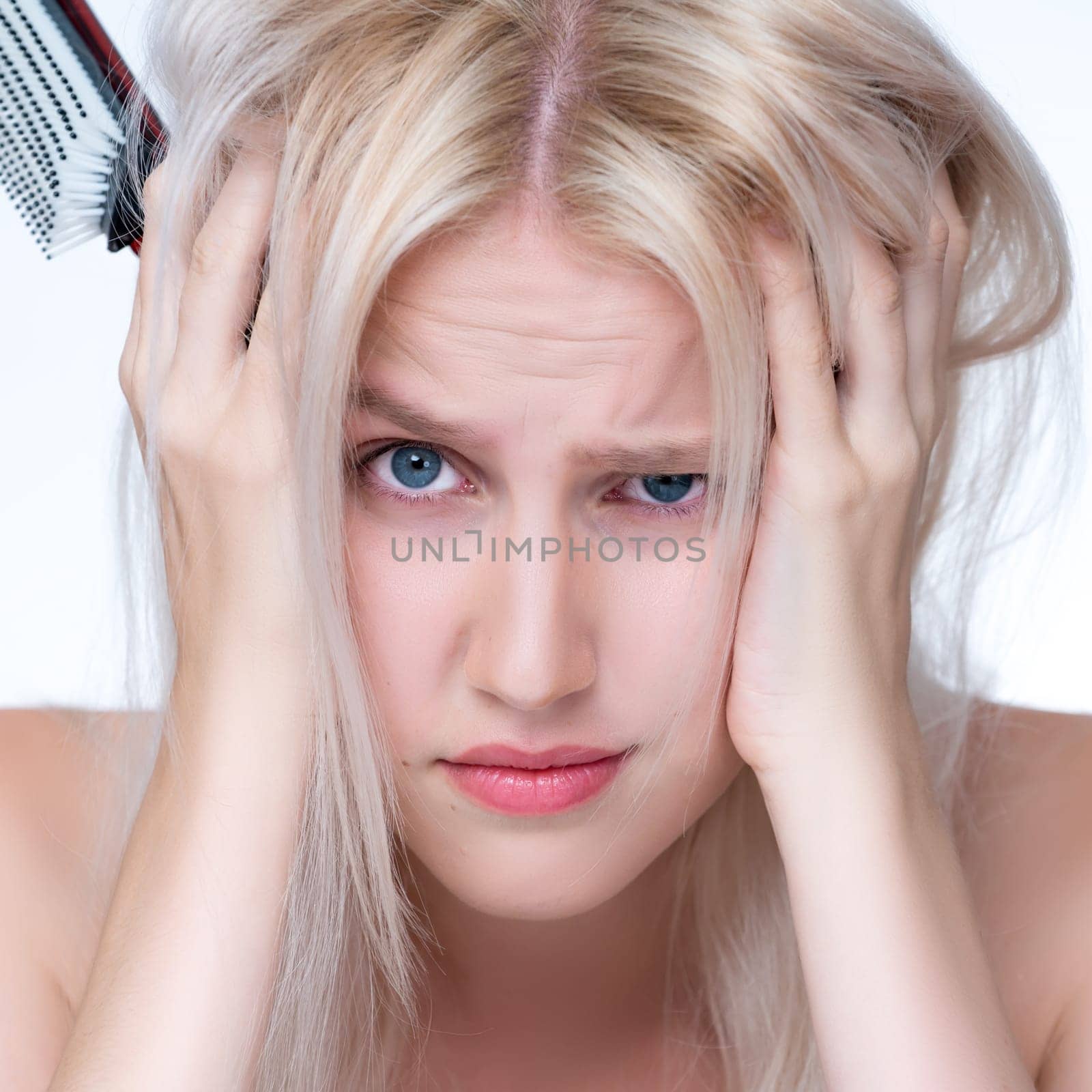 Closeup personable woman with cosmetic skin having dry hair loss problem. by biancoblue