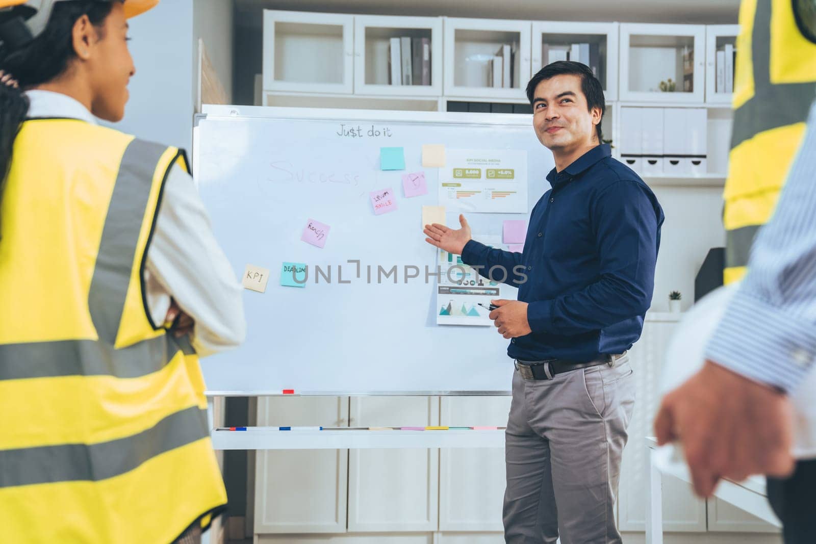 Entrepreneur brainstorming ideas with his competent engineers in the office. Architectural investors and engineers working on an upcoming project in a fun and friendly environment.