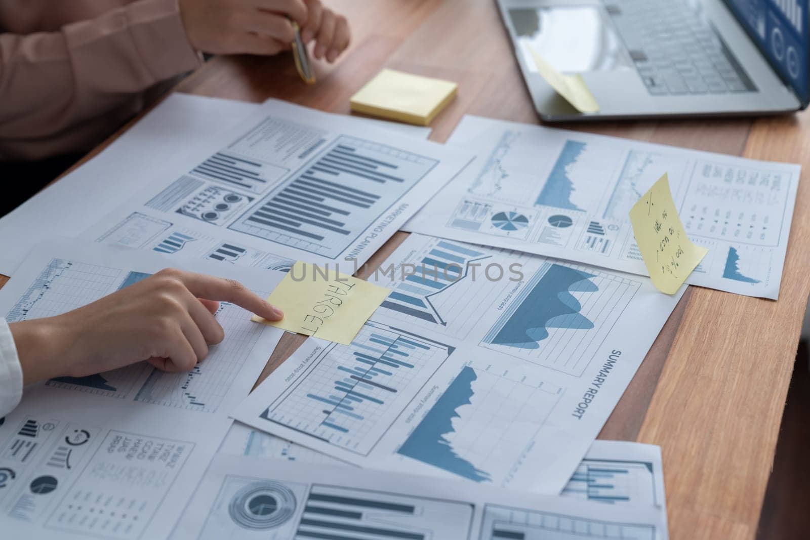 Closeup analyst team colleagues discuss financial data on digital dashboard, analyzing charts and graph with supportive teamwork. Professional office use BI to plan marketing business. Enthusiastic