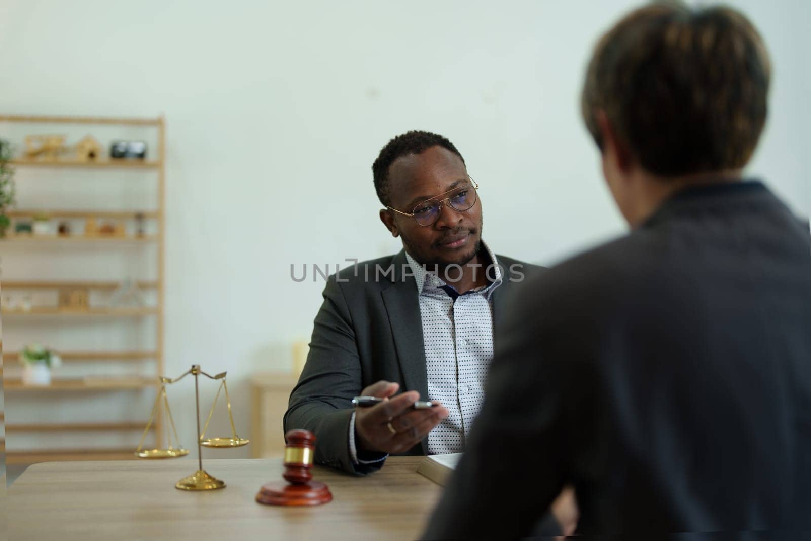 african american attorney, lawyers discussing contract or business agreement at law firm office, Business people making deal document legal, justice advice service concepts by Manastrong