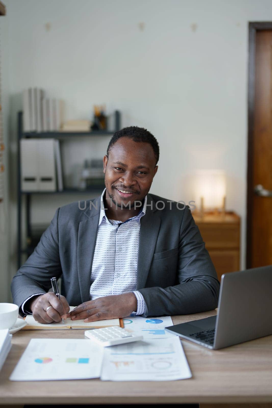 middle aged man American African using computer laptop with planning working on financial document, tax, exchange, accounting and Financial advisor. auditor or audit concepts.