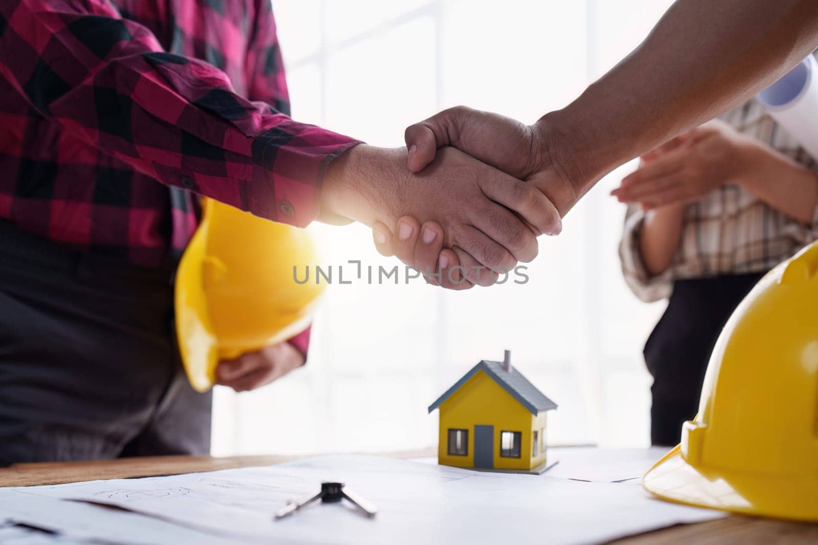 Foreman or Civil engineer handshake making modern construction. industry professional team and engineer concept by itchaznong