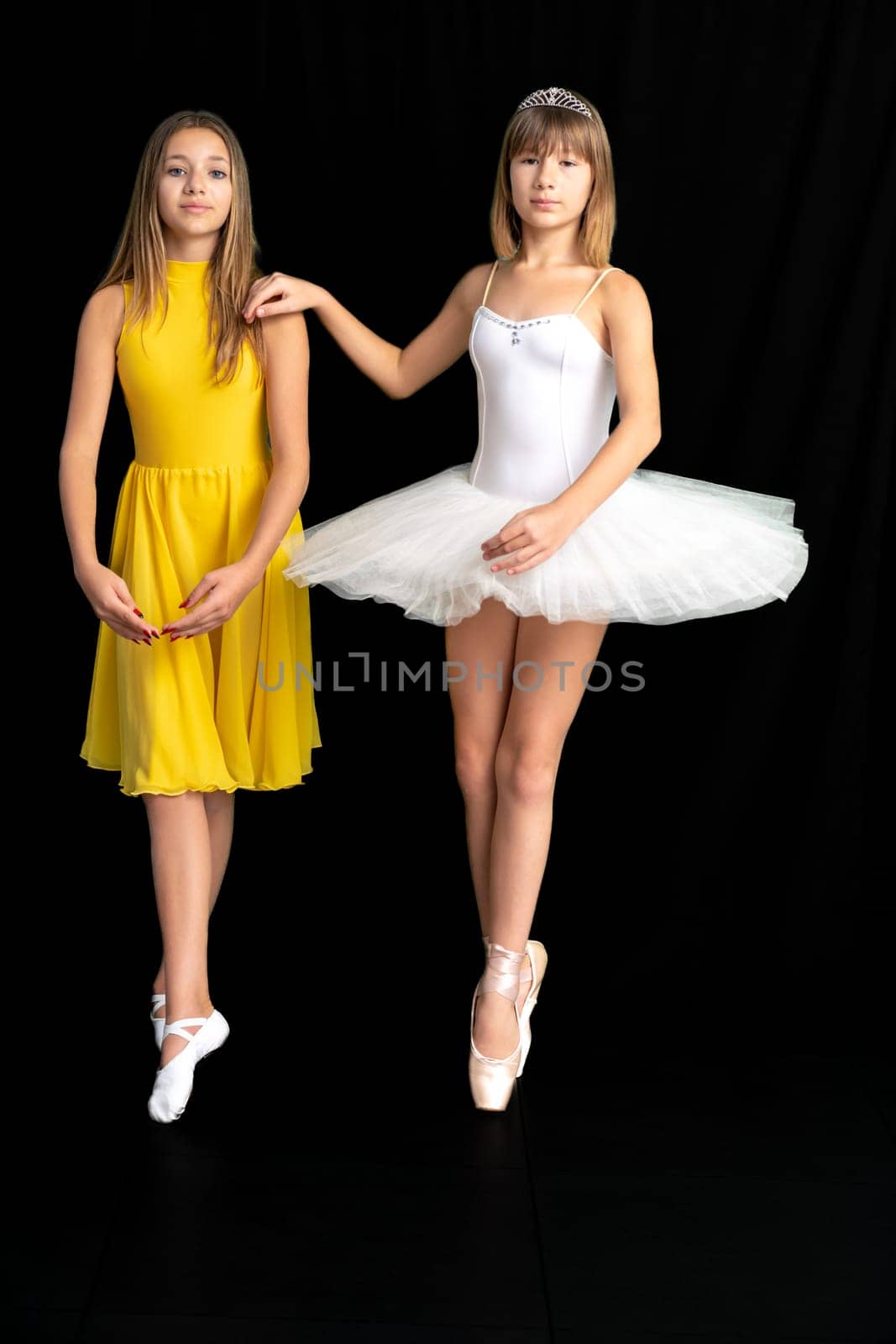 teenage ballerinas in the studio, portrait on a black background. High quality photo