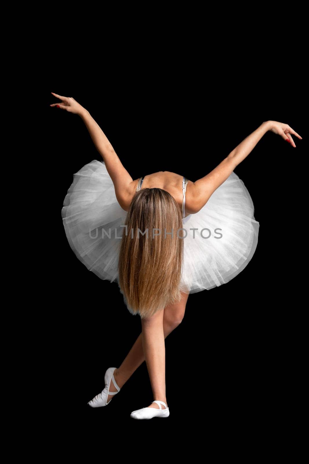 portrait of a ballerina in a pose, black background. High quality photo