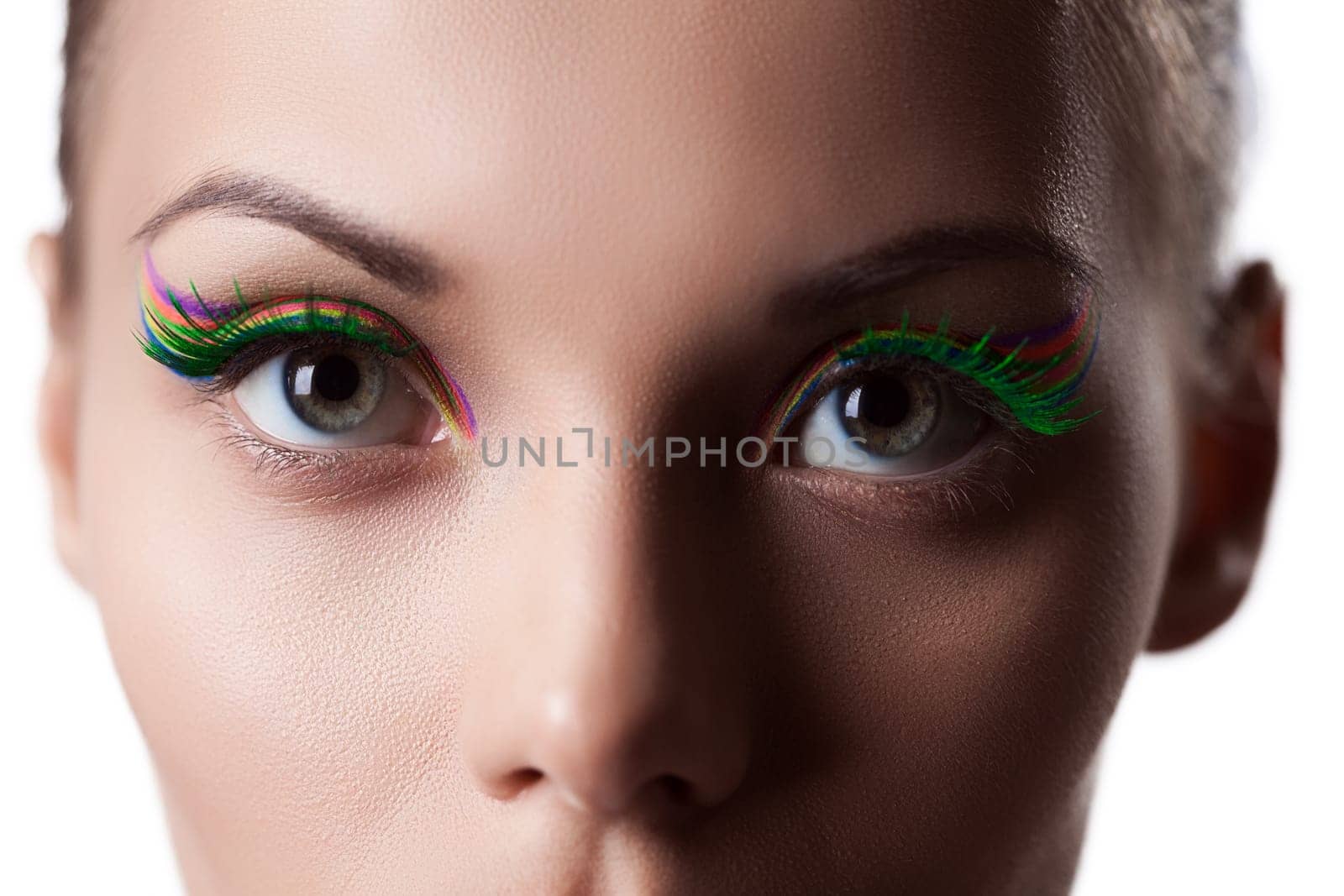 Eyes of young girl with bright UV makeup, close-up