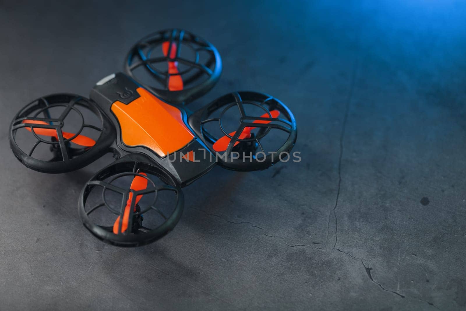 Gaming orange mini drone on a dark background by AlexGrec