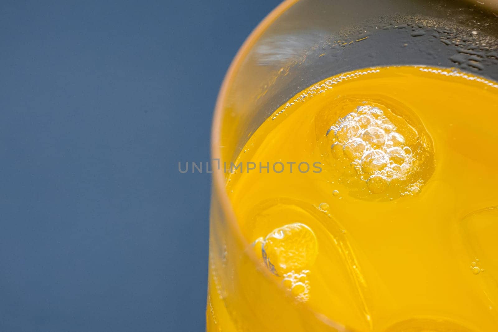 A bright yellow glass filled with freshly squeezed Passion fruit juice, providing a refreshing drink for the household.