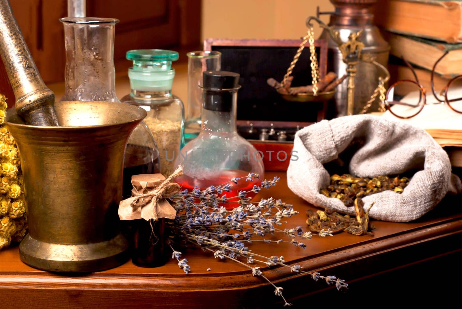 Dried healing herbs, flowers and candles, ritual purification , copyspace mortar and pestle near potions on wooden table. Close up of healing herbs alchemist stuff. Old pharmacy, alternative medicine concept.