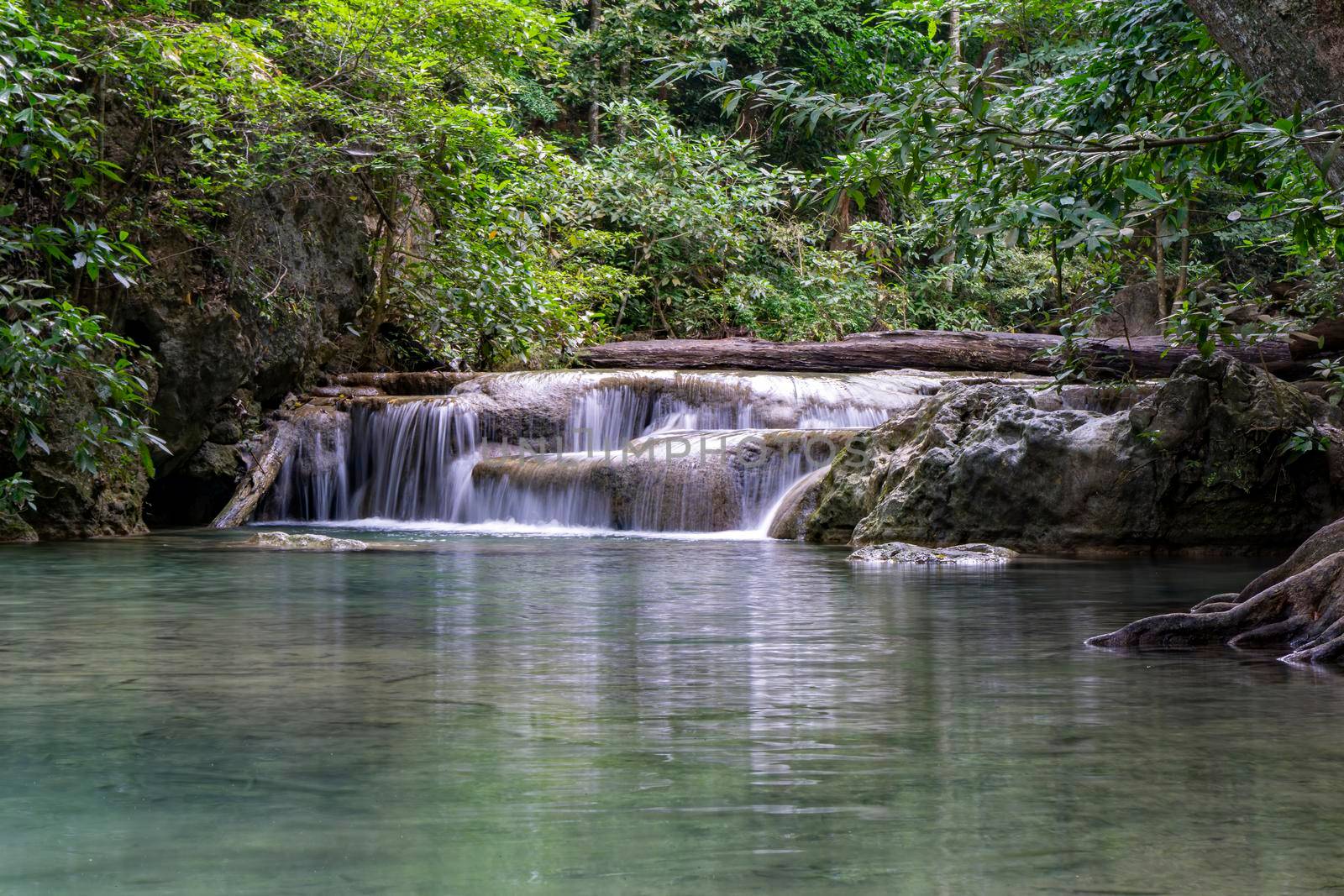Clean green emerald water from the waterfall Surrounded by small trees - large trees,  green colour, Erawan waterfall, Kanchanaburi province, Thailand