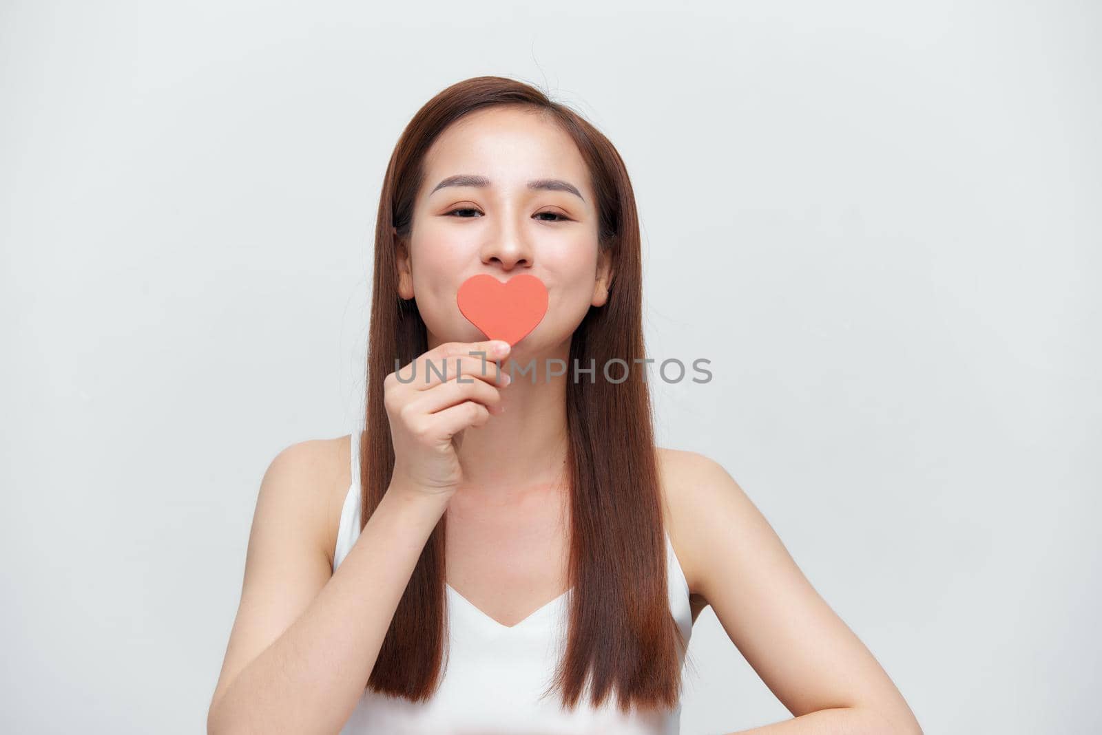 Asian woman with red heart on white background